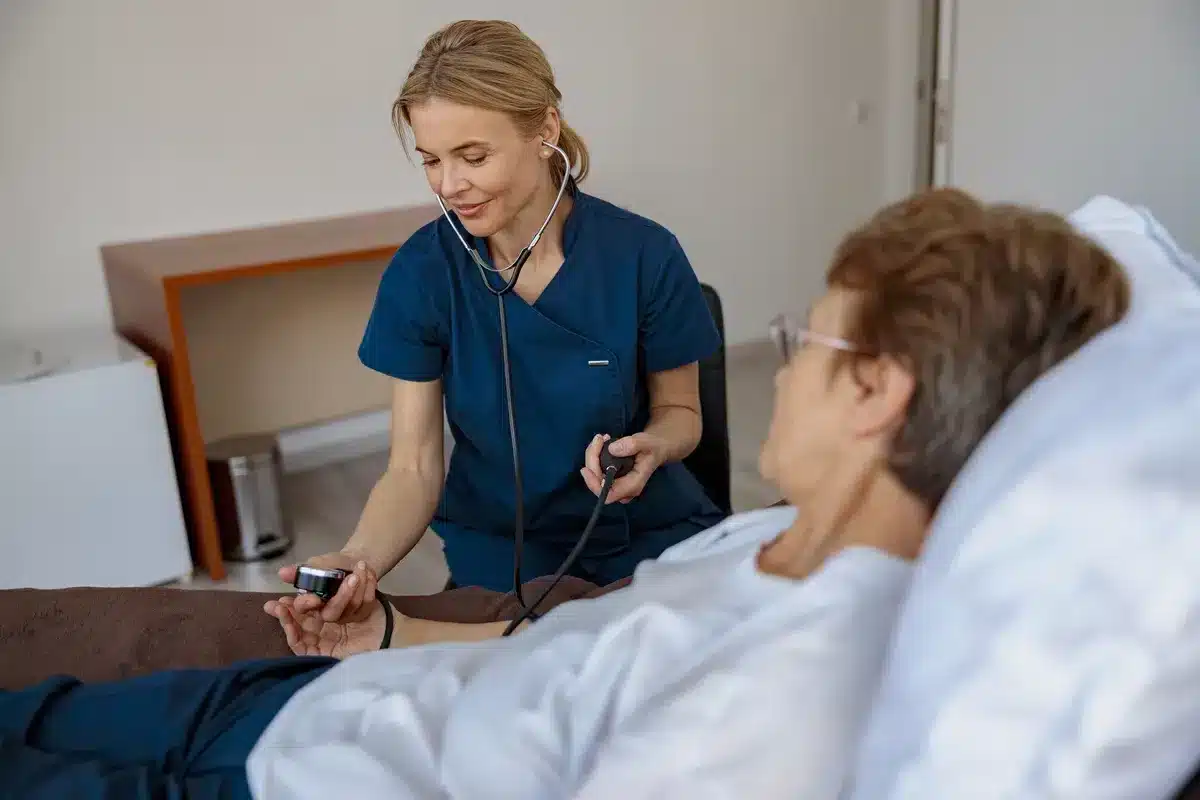 female-nurse-checking-blood-pressure-of-senior