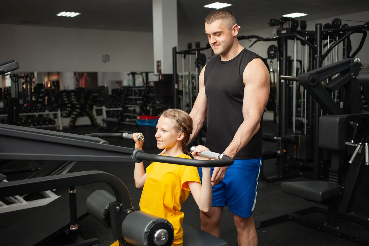 girl-performs-an-exercise-on-simulator