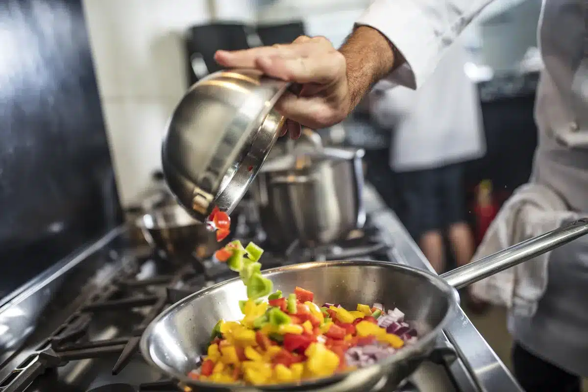 chef-pouring-sliced-vegetables