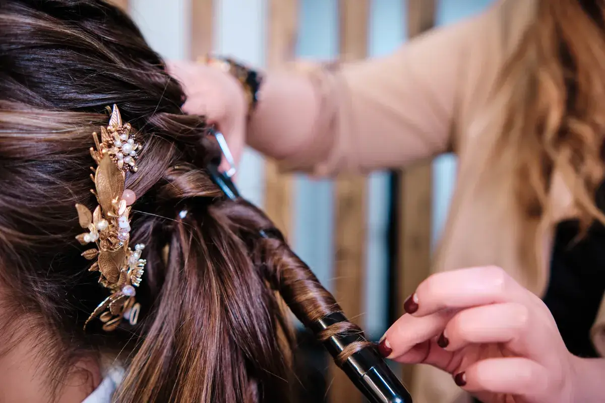 hairstylist-curling-a-client-hair